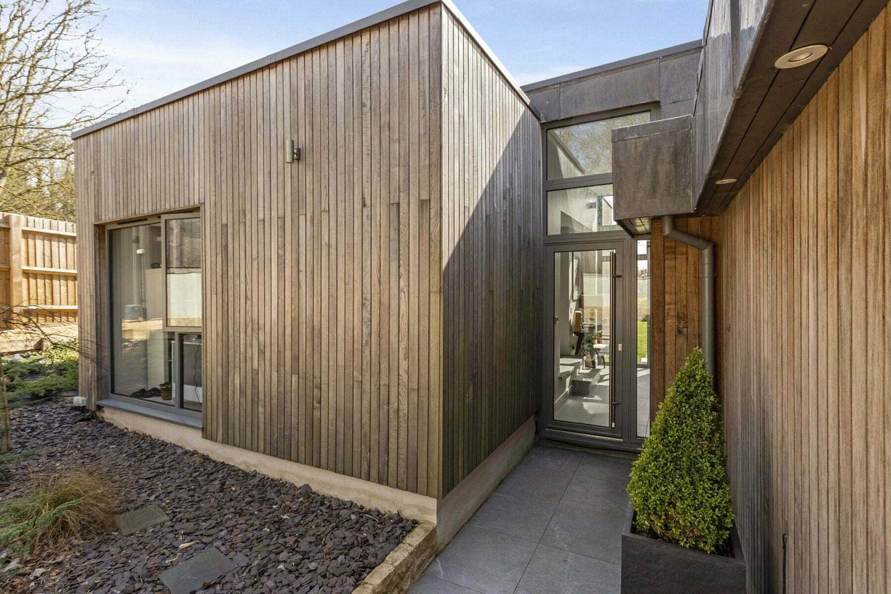 Brimstone Ash hardwood cladding designed to silver and blend with local limestone at Stonehurst