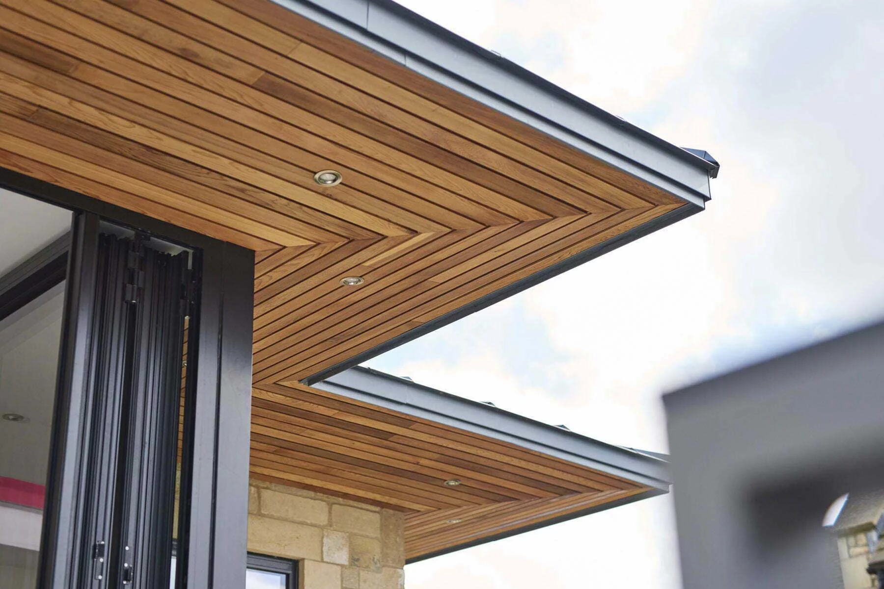 Close-up of the cedar canopy with recessed lighting for an elegant evening aesthetic.