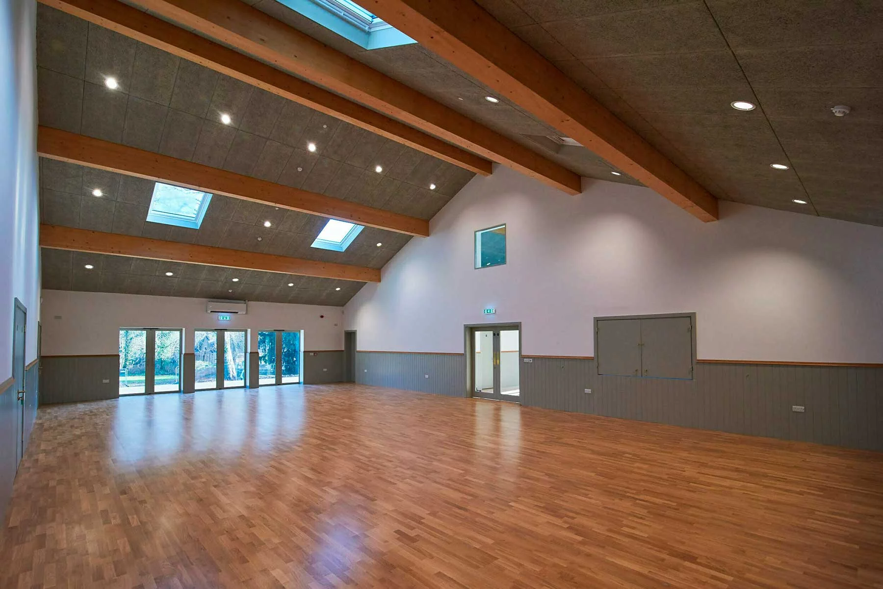 Perspective view of the main hall interior, showcasing the synergy between traditional materials and modern civic utility.
